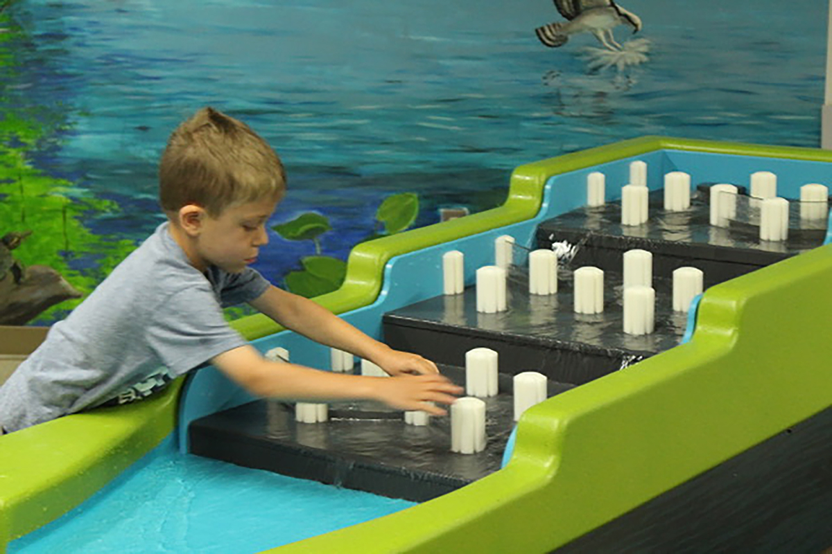 child playing with the La Crosse water table